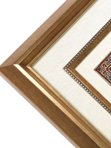 Another angle on the framed Jesus rug, highlighting the clean lines of the HDPS frame and the way the double matting draws the eye inward towards the artwork.