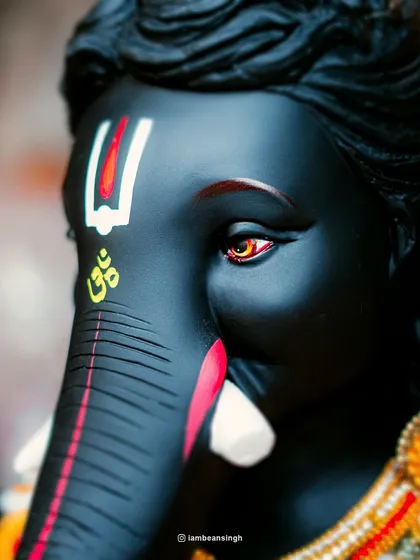The details are where the devotion truly lies. This close-up of a magnificent black Ganpati idol focuses on the expressive eyes and the sacred 'Om' symbol. Capturing these intricate details is how I tell the story of the artistry and faith behind each idol.