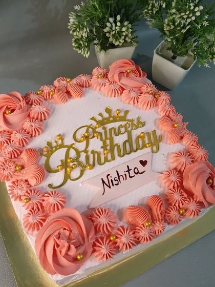 A lovely square cake with pink piping and a "Princess Birthday" topper.