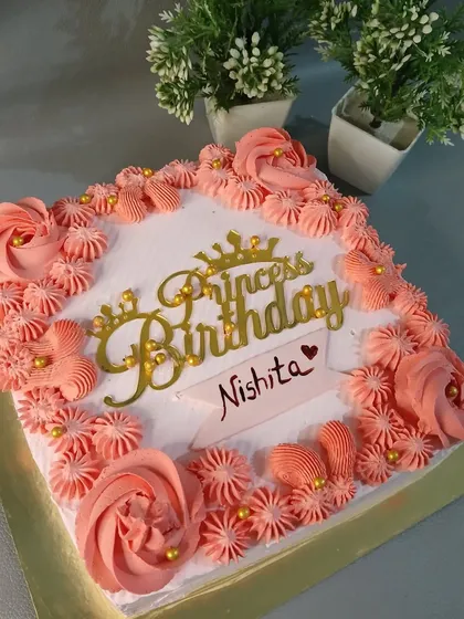 A lovely square cake with pink piping and a "Princess Birthday" topper.