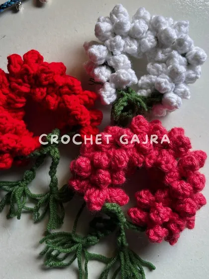 A close-up of my crochet gajras, available in classic white, vibrant red, and pretty pink. Each one is handcrafted to look like a real mogra gajra but lasts forever.