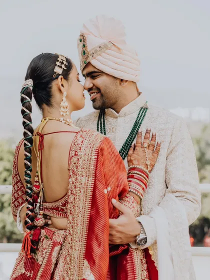 A beautiful portrait from the back, highlighting the bride's stunning hairstyle and the couple's intimate connection.