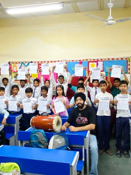 At a school workshop, students hold up their certificates of participation. I love taking the joy of tabla to schools across the city.