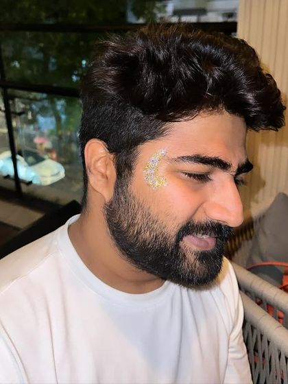 A subtle gold and silver glitter design on a bearded client. The sparkle adds a festive touch without being overwhelming.