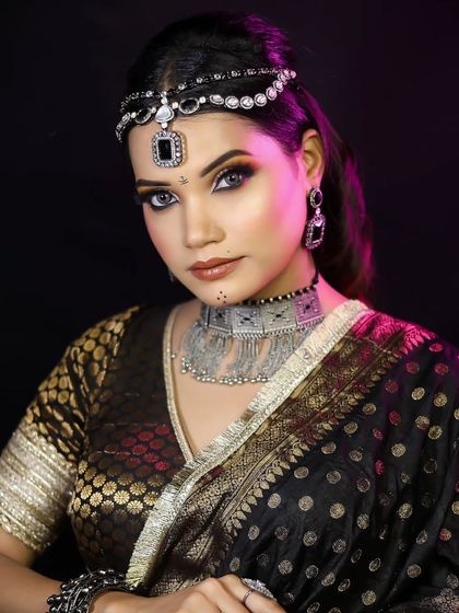 The final look, featuring a bold smokey eye and statement silver jewelry.