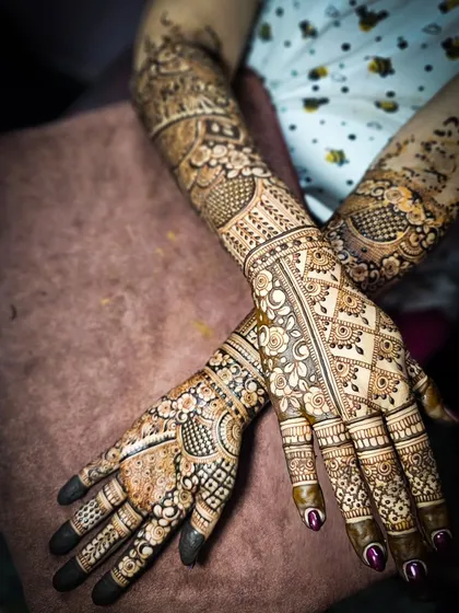 A top-down view of a complex bridal design, featuring a mix of floral, geometric, and traditional elements.