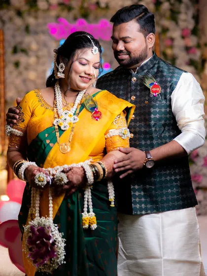 Another shot of the happy couple, giving a better view of the custom 'Aai' and 'Baba' brooches with peacock feathers.