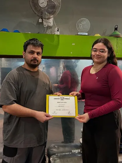 Presenting a certificate to another successful student. Her focus and determination are an inspiration to others in the class.