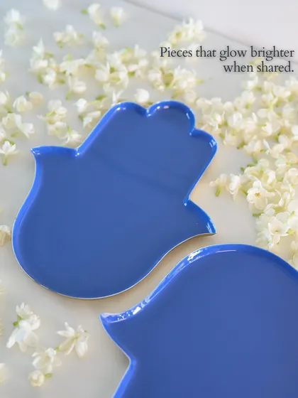 Pieces that glow brighter when shared. The Hamsa hand, a symbol of protection and blessings, is reimagined here as a vibrant blue plate, perfect for sharing savouries or as a meaningful gift.