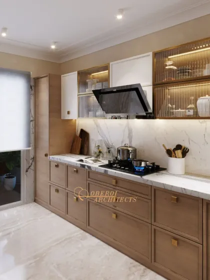 This view focuses on the cooking zone, with an integrated hob and chimney set against a beautiful marble backsplash that extends up the wall.