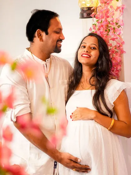 A lovely couple portrait from a maternity session. The simple act of standing together, framed by our pink floral arch, creates a timeless and classic memory of their journey.