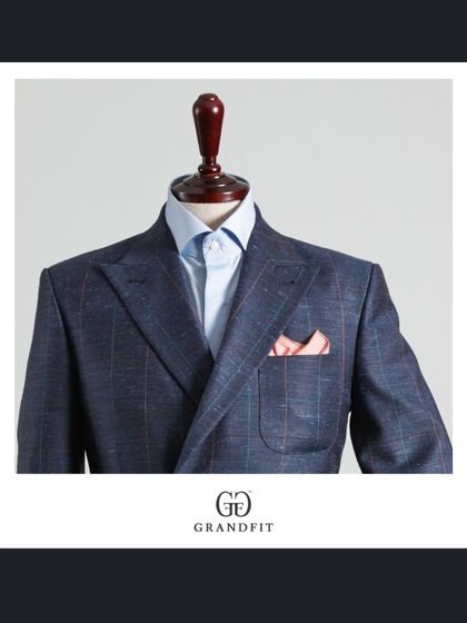 A closer look at the blue double-breasted blazer, highlighting the patch pockets and the vibrant pocket square, details that lend it a contemporary feel.