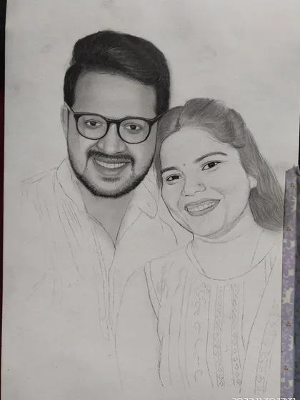 Another progress shot of the couple's portrait, showing the gradual process of adding shading and detail to bring the drawing to life.