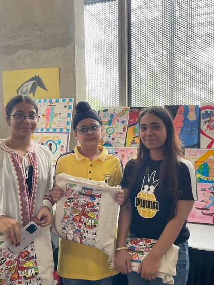 Young winners of a student art competition proudly display their prizes during Bastille Day. We encourage creativity and participation from all age groups in our community events.