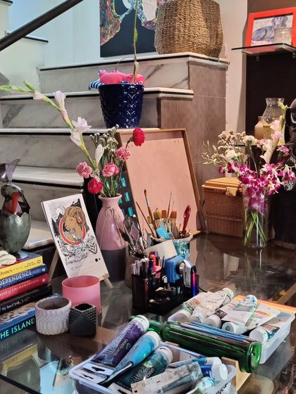 My 'brick and mortar magic shop'. A corner of my studio showing my tools of the trade: paints, brushes, books, and collected objects that inspire me.