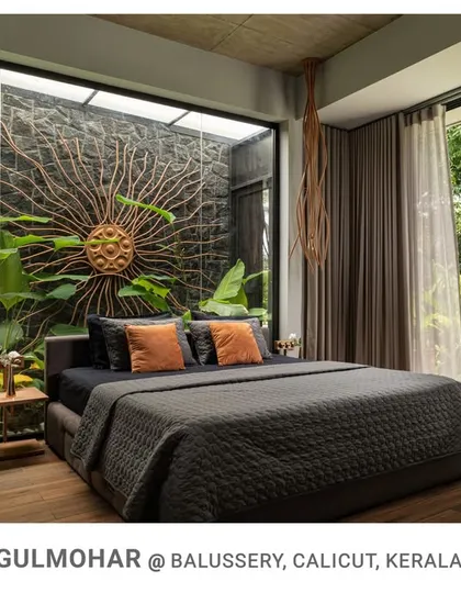 I design bedrooms to be personal sanctuaries. This space at Gulmohar opens directly onto a private courtyard, featuring a custom sun-ray art piece against a natural stone wall, merging the indoors with a serene, personal garden.
