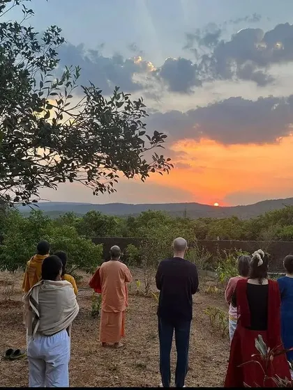 A group of students joins me for a sunrise meditation at the ashram. Sharing these moments of stillness and natural beauty is a core part of our community practice and sadhana.
