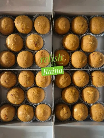 Four boxes of Besan Laddoos with almonds. The slow-roasting process is time-consuming but absolutely worth it for the authentic taste.