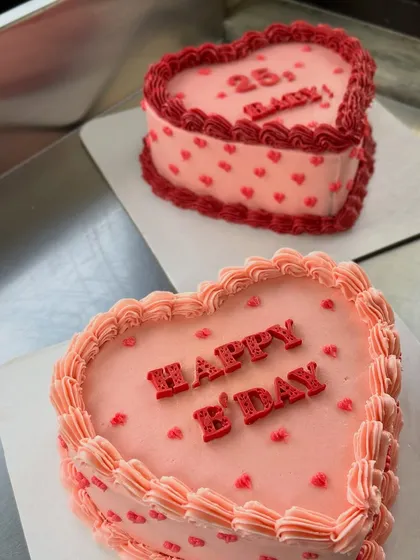 Two heart-shaped birthday cakes ready to go. I love the classic look of the piped borders and tiny heart details.