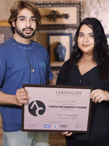 Presenting a certificate to another talented student. Her passion for makeup is clear.