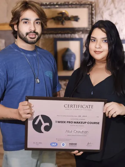 Presenting a certificate to another talented student. Her passion for makeup is clear.