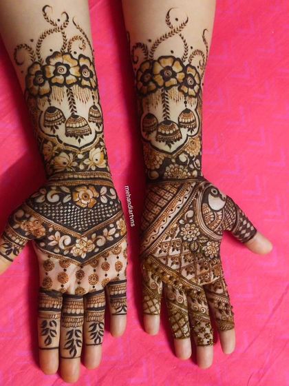 This design combines floral bouquets with hanging jhumkas and peacock motifs, blending modern and traditional elements beautifully.