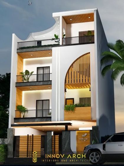 An alternate view of our modern residence design for Noida Sector 26. This angle provides a clearer look at the interplay between the solid white structure, the dark frames, and the natural palm trees, showcasing a harmonious blend of architecture and landscape.