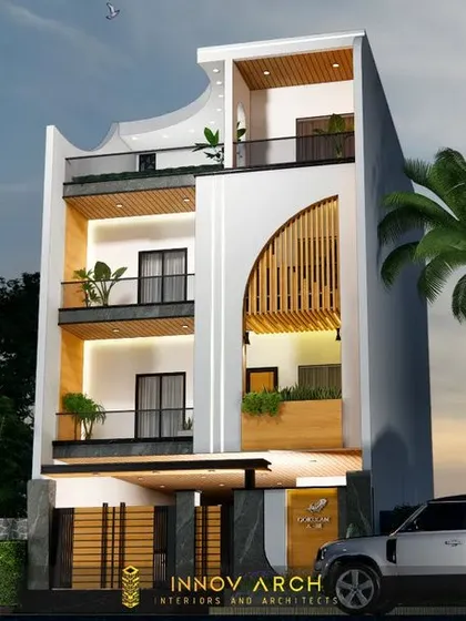 This is the first view of a luxurious residence I'm designing in Noida Sector 26. The facade uses a modern and elegant theme, with curved elements, wooden louvers, and large glass balconies to create a sophisticated and airy feel.