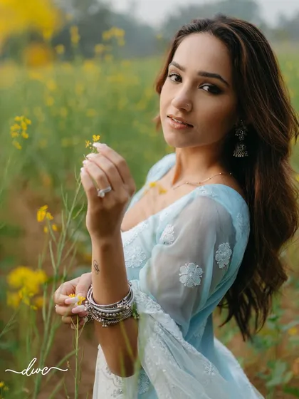 A beautiful portrait of the bride-to-be in a field of mustard flowers, her serene expression and the golden surroundings creating a dreamy, romantic image.