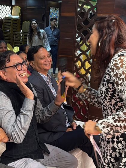 Sharing a laugh with the guests. I move around the room, interacting with everyone to ensure the energy is high and the atmosphere is friendly and fun.