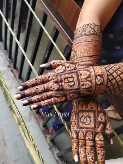 The back of a bridal design, with a grid pattern featuring the couple's initials and other small, traditional motifs.