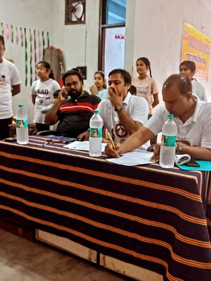 The examiners carefully watch and score each student's performance. Every detail, from stance to kiai, is noted.