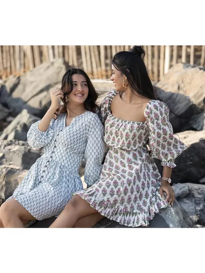 A beachside fashion shoot for a clothing brand. The natural setting and relaxed interaction between the models create a perfect lifestyle look for a summer collection.