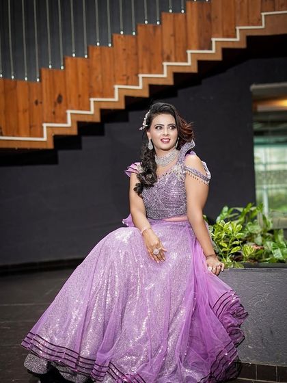 A beautiful portrait of a client in a sparkling lavender gown. The intricate beading on the bodice makes this a glamorous choice for any party.