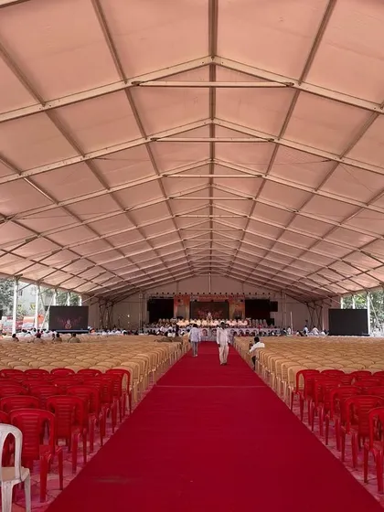This image shows the sheer size of one of our German hanger tents before the event begins. The vast, pillar-less interior can be configured with thousands of chairs for political rallies, corporate conferences, or other large-scale gatherings.