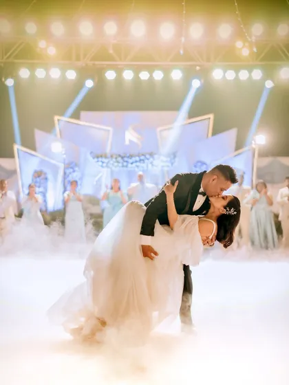 A show-stopping first dance dip, complete with stage lights and dramatic fog. I make sure to capture the peak moments of your reception that feel like they're straight out of a movie.