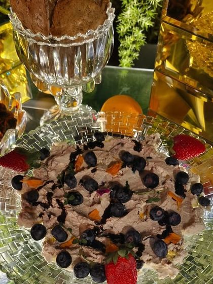 A beautifully arranged dip platter, topped with fresh berries and served with crackers. Our grazing tables are known for their abundance and artful presentation.