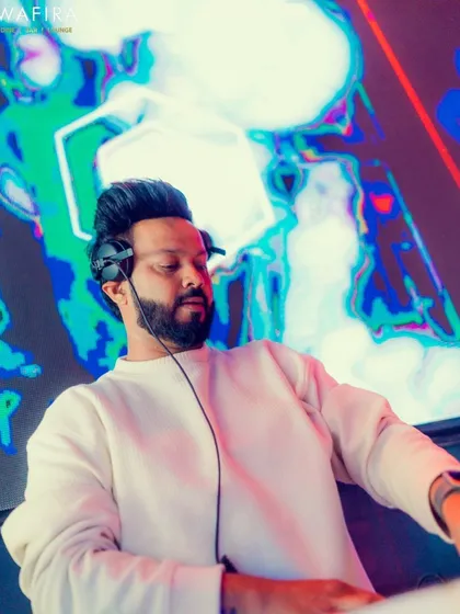 In the zone, with my custom visuals lighting up the background. As a VDJ, I create a complete audio-visual story that makes every track a spectacle.