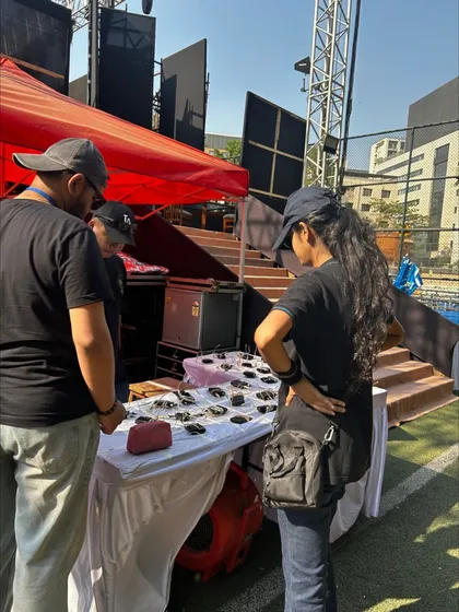 Managing the distribution of actor microphones and equipment backstage at the DAIS Annual Day. Our backstage management ensures all performers are ready for their cues.