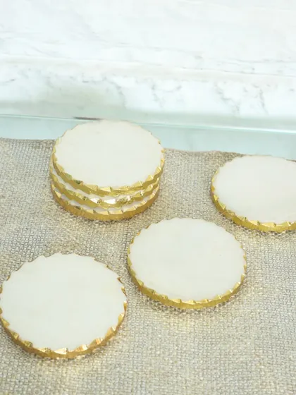 Our handcrafted marble coasters with a simple gold-leafed edge. Carved from natural stone, each piece in this set of six is uniquely beautiful, adding a touch of understated elegance to your table.