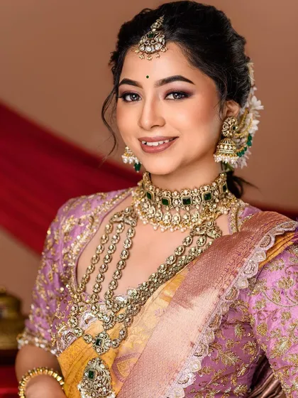 A classic bridal portrait with a focus on the stunning layered jewelry. The soft smile and gentle pose create a timeless and elegant image, perfect for any bridal portfolio.