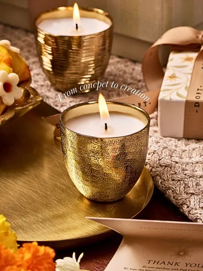 Every candle tells a story. This image, showing the journey from concept to creation, reveals how ancient coins became the muse for my Metallic Votive Candle, transforming their textures into vessels that hold light.