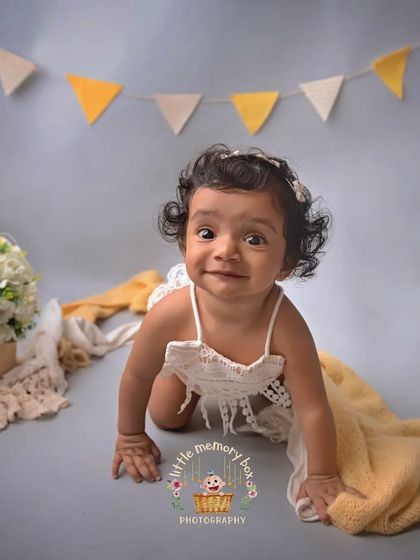This little crawler is on the move. Capturing these active moments is part of the fun of a toddler session. Her cheeky smile says it all.