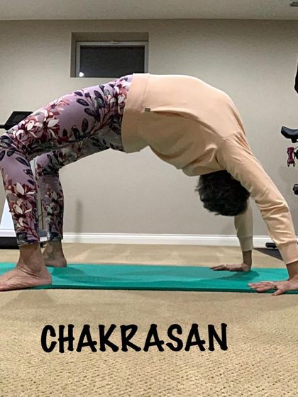 Practicing Chakrasana at home. This advanced backbend can be achieved with consistent practice of preparatory poses.
