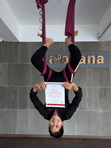 Another student celebrating her certification upside down. We love the playful spirit of our aerial yoga family.