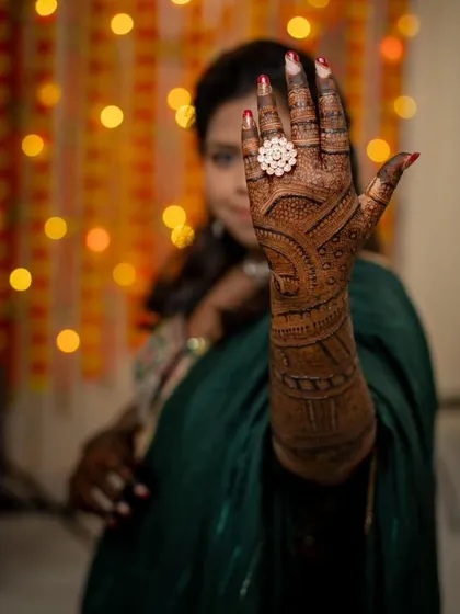 This shot focuses on the intricate design on the palm and back of the hand. The rich brown stain is clearly visible, showing the beautiful result of my organic henna.