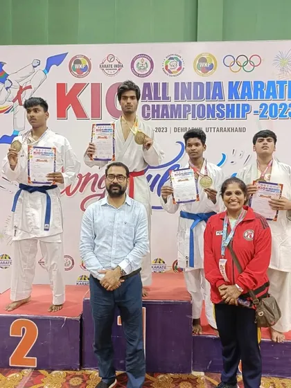 Harshit Pandey standing tall on the podium after winning gold at the KIO All India Karate Championship 2023.