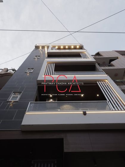 A daytime view of 'The Cursive Abode' with its integrated lighting turned on, showcasing how the design elements function in both daylight and evening settings.