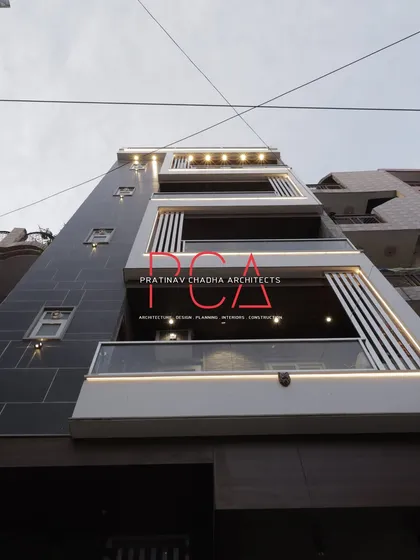 A daytime view of 'The Cursive Abode' with its integrated lighting turned on, showcasing how the design elements function in both daylight and evening settings.