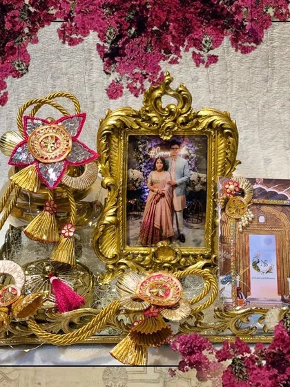 A framed version of the personalized engagement hamper, highlighting the beautiful combination of the couple's photo and the traditional golden decor.